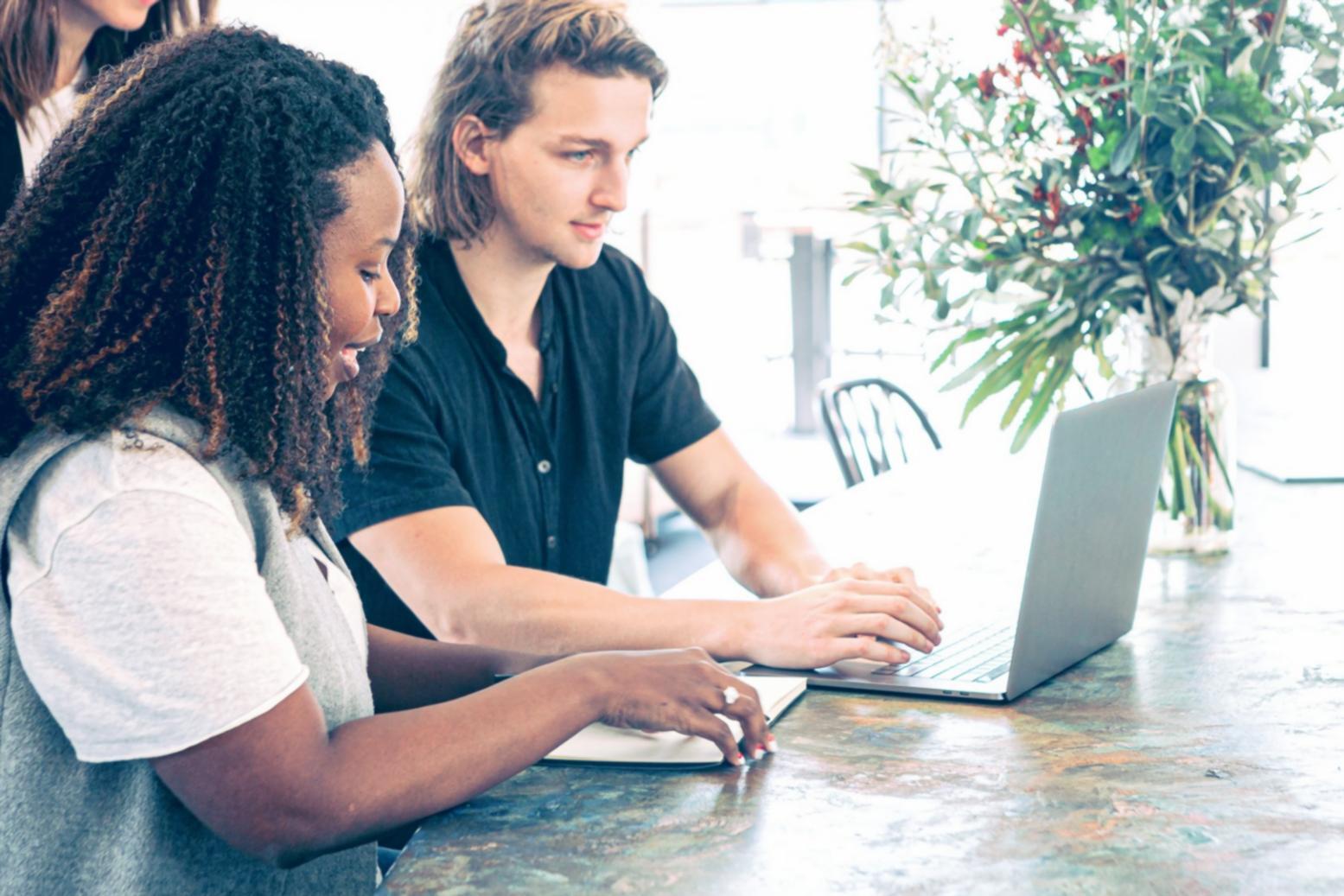 International students collaborating on investment analysis in a modern learning environment